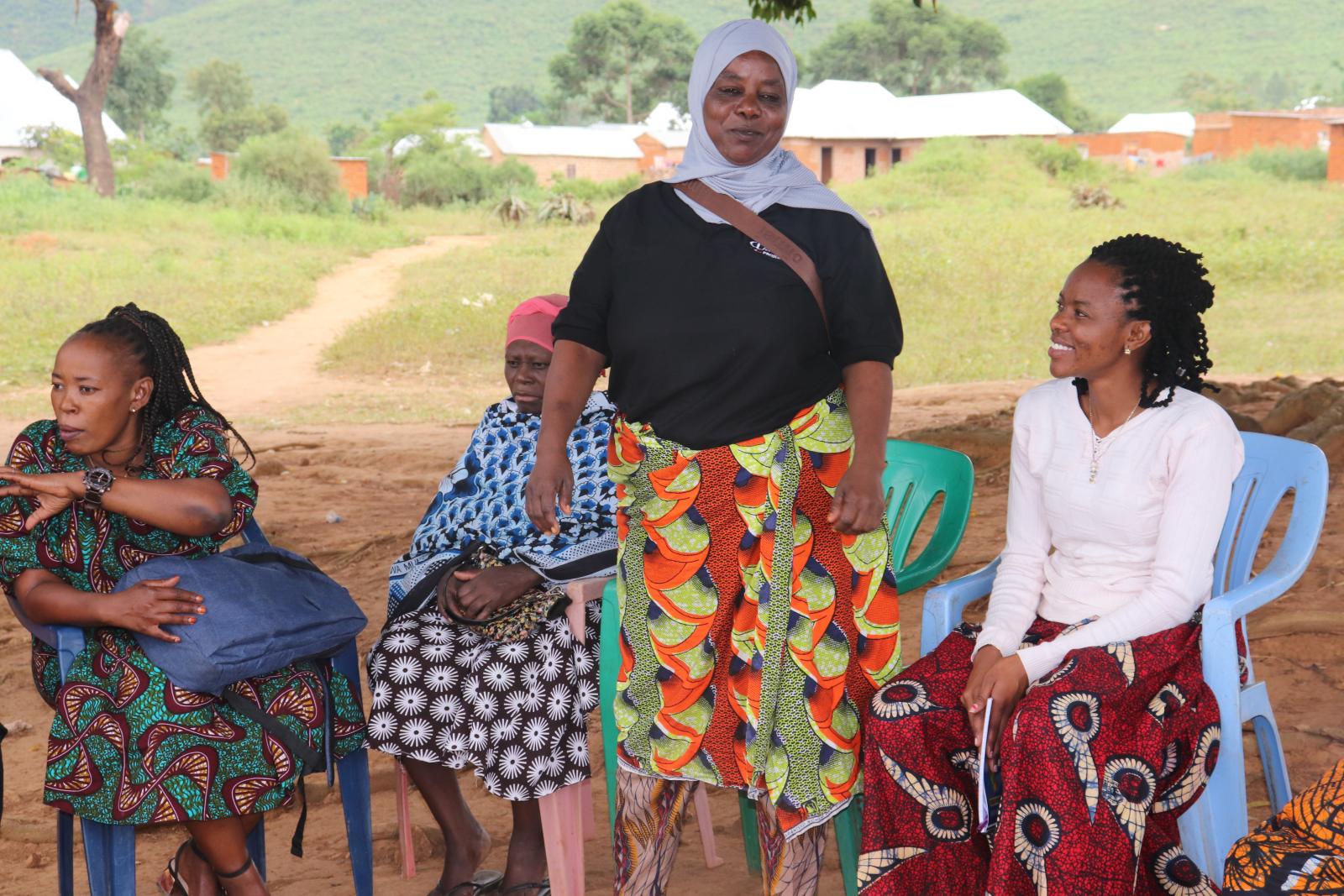 Asia Hussein (standing) chairperson of Geita Woman Miners Association (GEWOMA) addresses a meeting. Mgusu, Geita region.